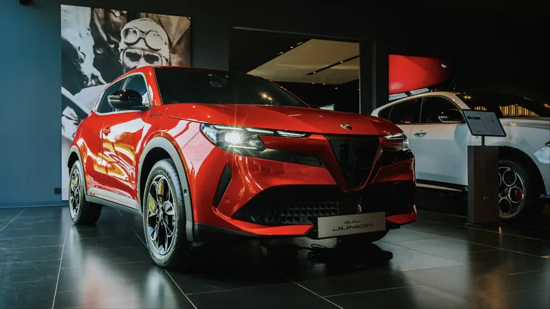 A red electric SUV on display in a car showroom